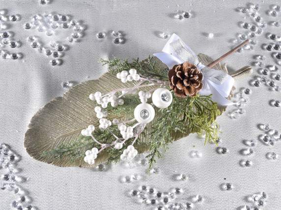 Artificial sprig of white berries and snow-covered pine cone