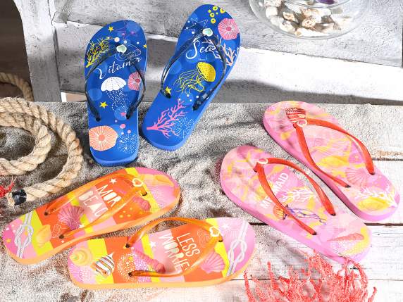 A pair of womens flip flops with glitter string At the bott