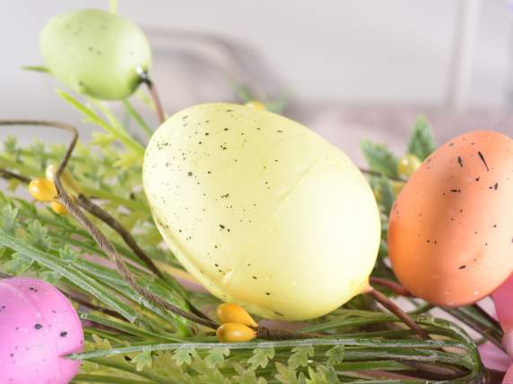 Artificial colored eggs and leaves branch