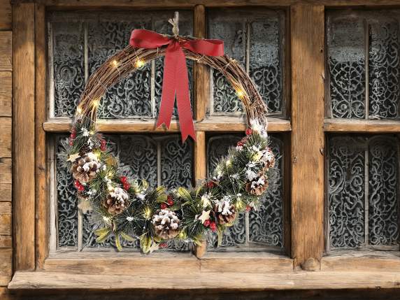 Garland of pine branches, pine cones, snowy berries and LED