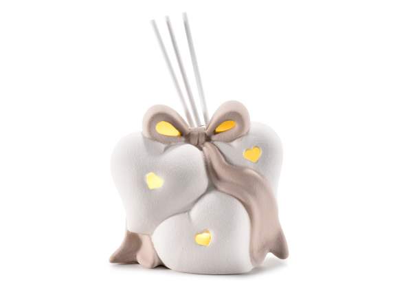 Coeurs en porcelaine avec noeud et lumières avec bâton de pa