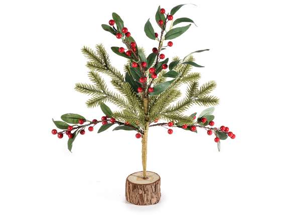 Artificial tree with pine branches and berries on wooden bas