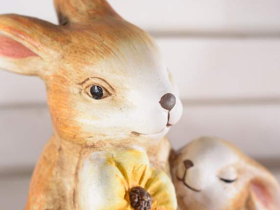 Pair of terracotta parent-child bunnies with flower
