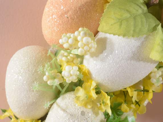 Wreath with glitter eggs, berries and flowers
