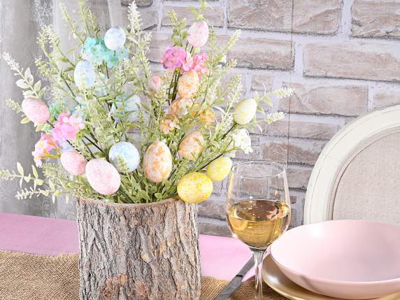 Branch of colored eggs and artificial leaves