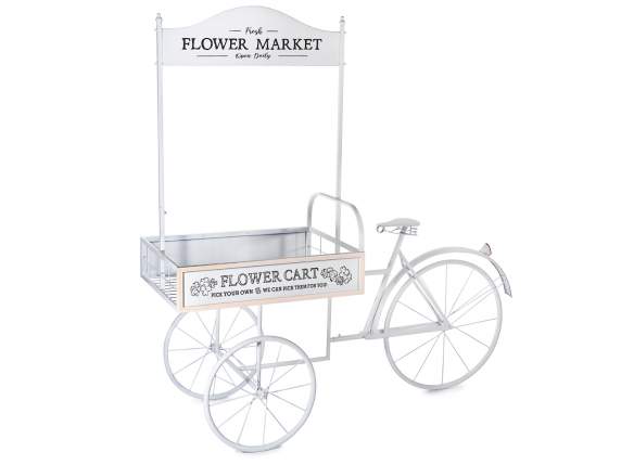 White metal display cart with bicycle and sign