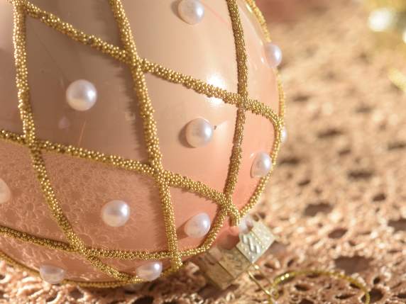 Glass ball with pearls and golden decorations