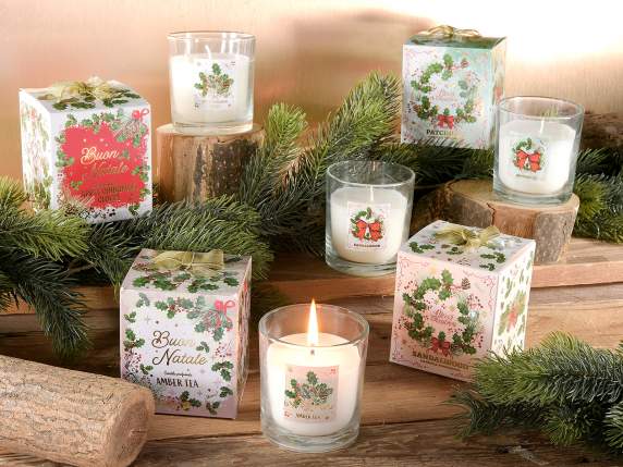 Scented candle in glass jar with holly decorations