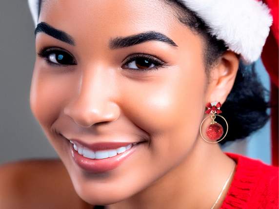 Pair of metal earrings with ball and bow with display