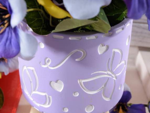 Cement vase on wooden tripod with bas-relief decorations