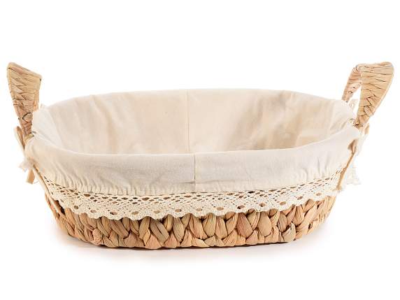 Woven hyacinth basket with handles and fabric covering