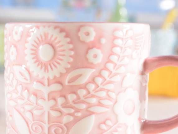 Porcelain cup with floral decorations in relief