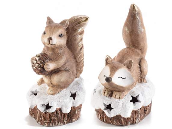 Terracotta fox and squirrel on a snowy trunk w-light