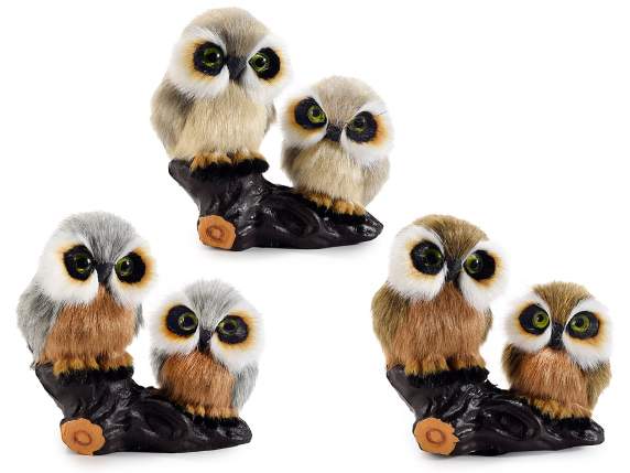 Pair of fake fur owls on trunk to place