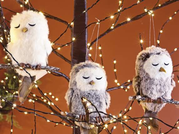 Soft eco-fur little owl asleep on the branch to hang