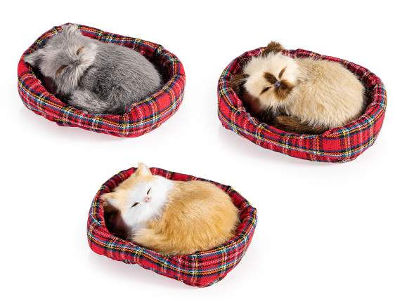 Decorative cat in fake fur asleep in its bed