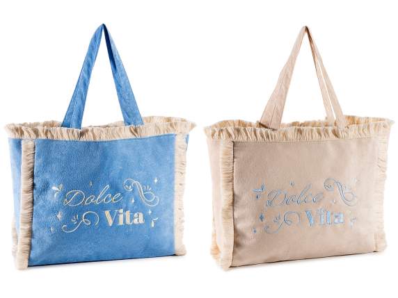 Fabric bag with handles and fringes and embroidered writing