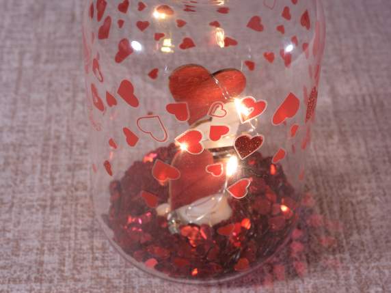 Glass jar decorated with heart sequins and LED lights