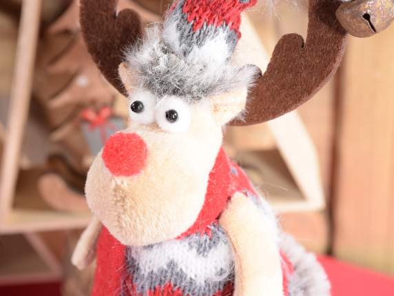 Christmas reindeer in knitted dress and bell on hat