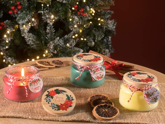 Scented candle in glass jar with Christmas decorations