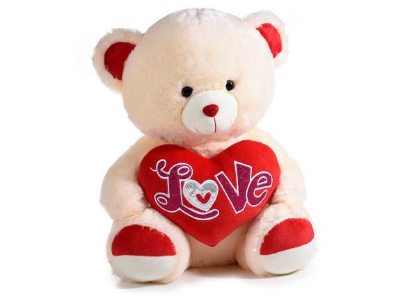 Sitting teddy bear with heart and Love writing