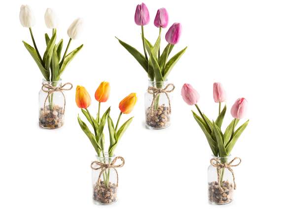 Glass jar with artificial tulips, pebbles and a bow