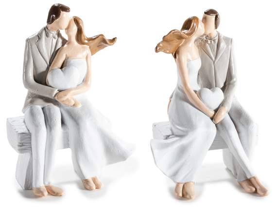 Resin couple in love sitting on a bench