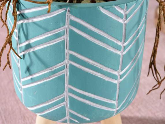 Colored and decorated concrete vase on wooden tripod