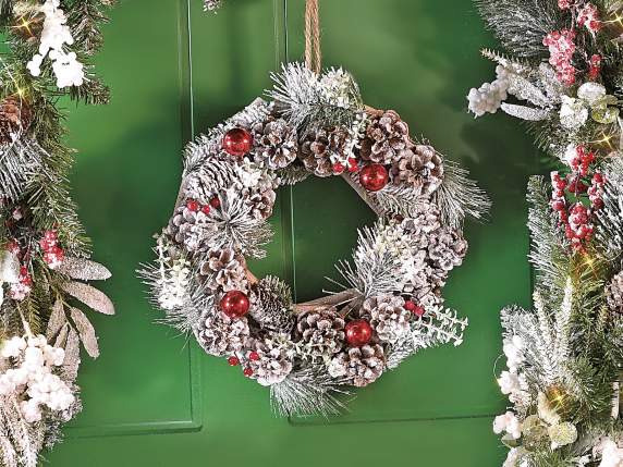 Snowy wooden wreath with pine cones and berries to hang