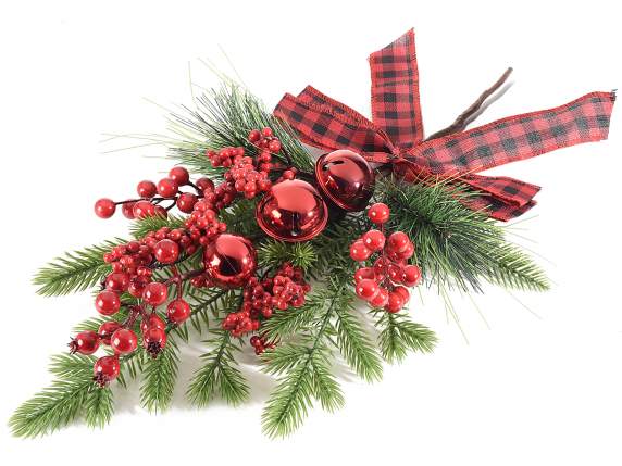 Pine branch with red berries, balls, bells and bow